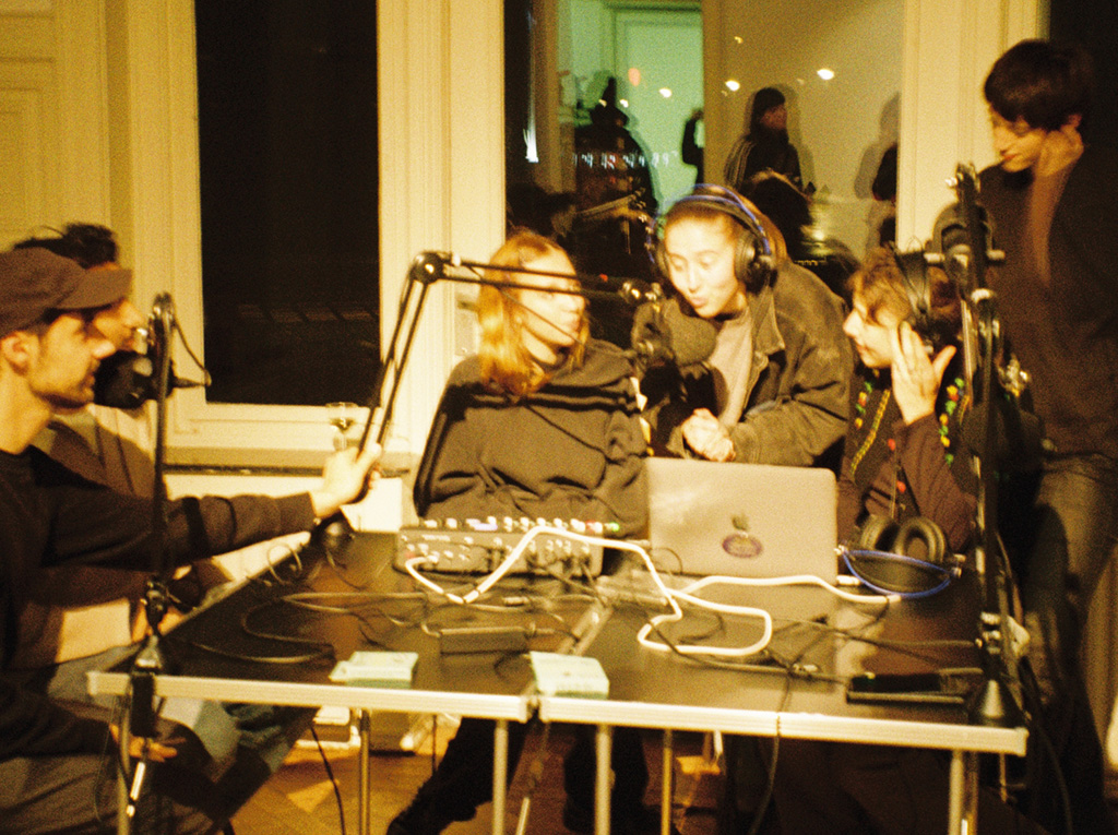 Group of people recording audio and conversations around a rectangular table