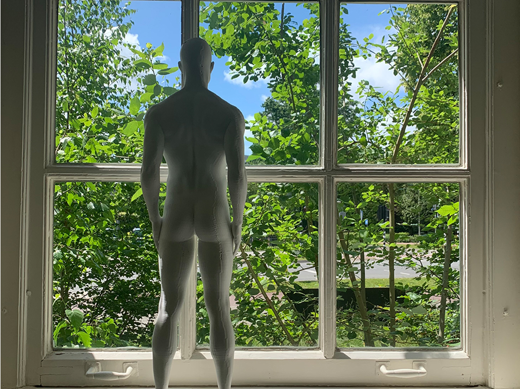 Human figure maquette in front of the window