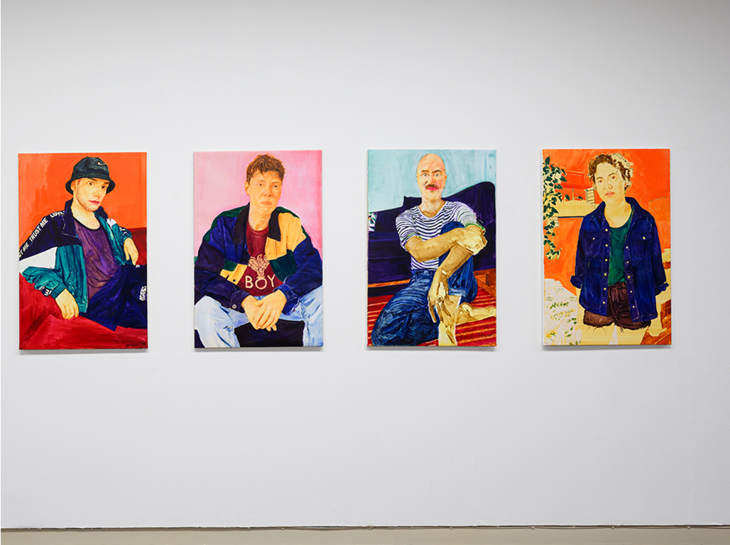 Serie of colourful artwork hanging on a white wall.