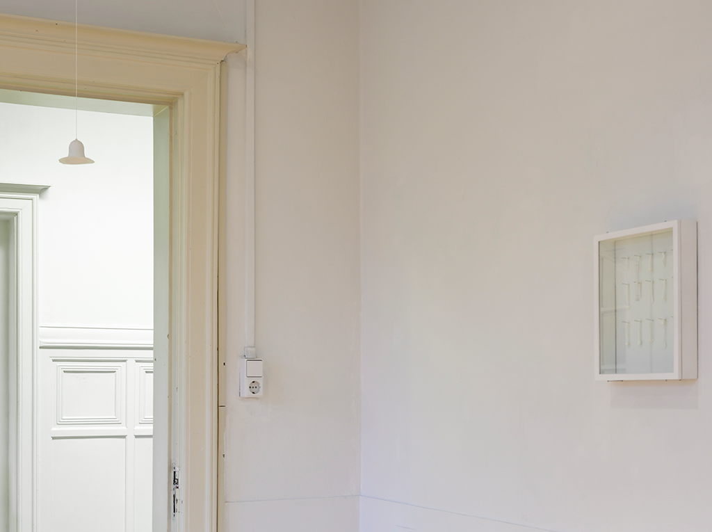 Small white ceramic pieces hanging from the walls.