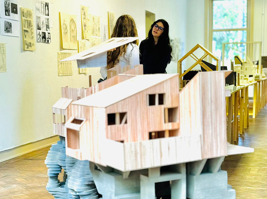 A architecture maquette displayed in a white room.