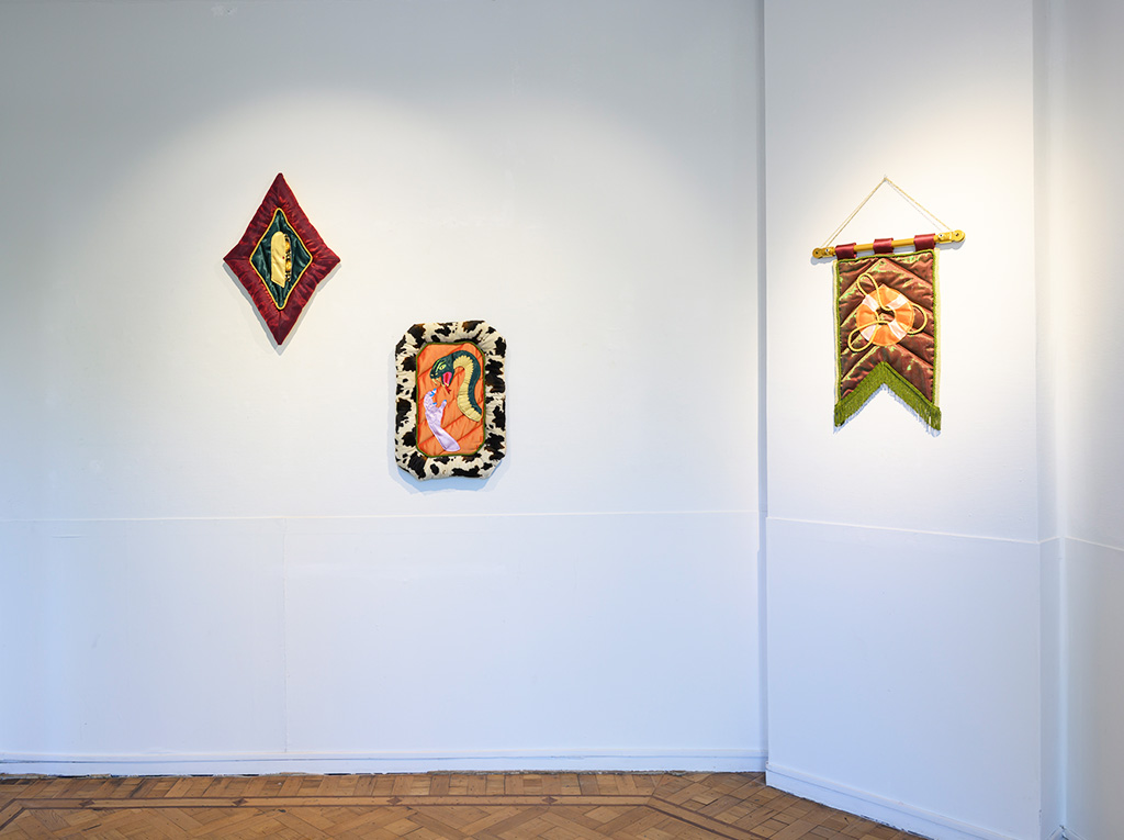 Overview of textile banners hanging on a white wall