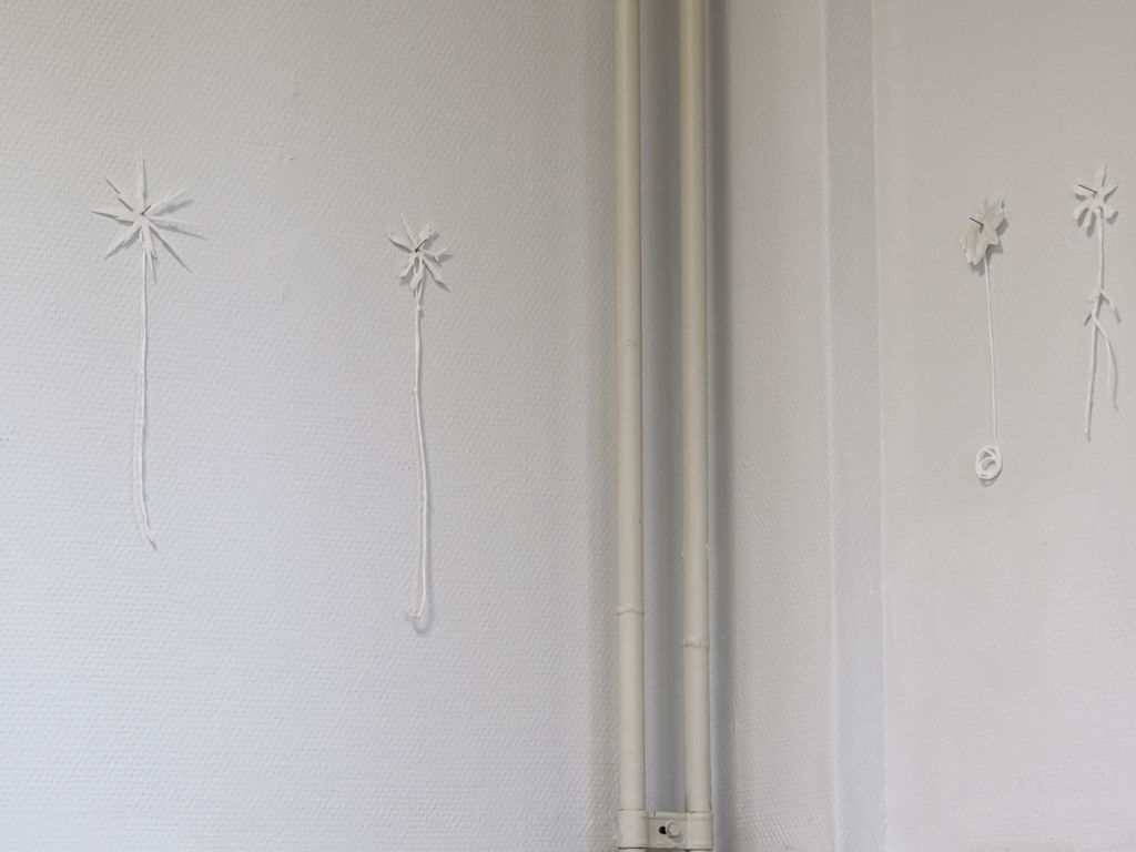 Small white ceramic pieces hanging from the walls.