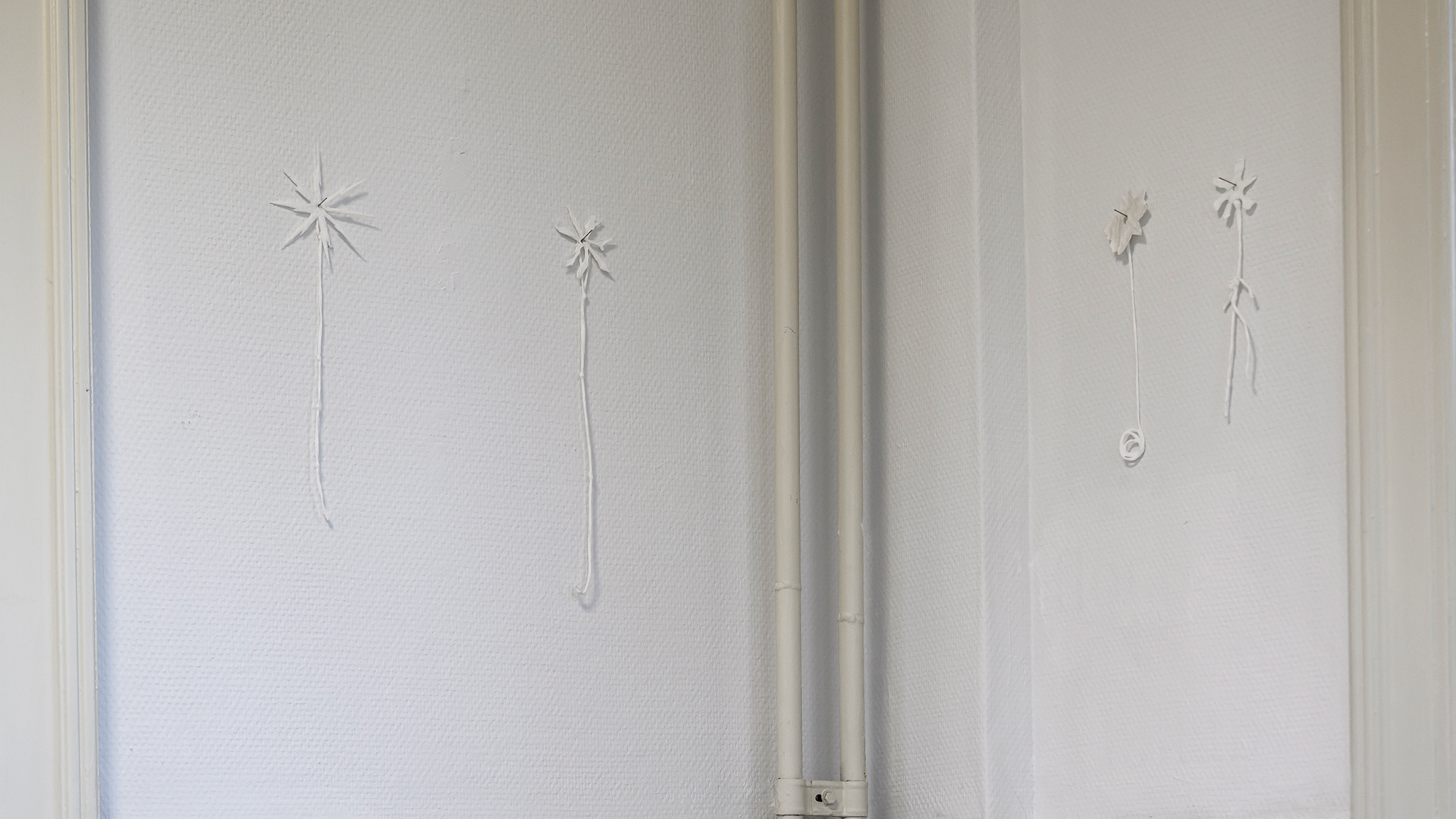 Small white ceramic pieces hanging from the walls.
