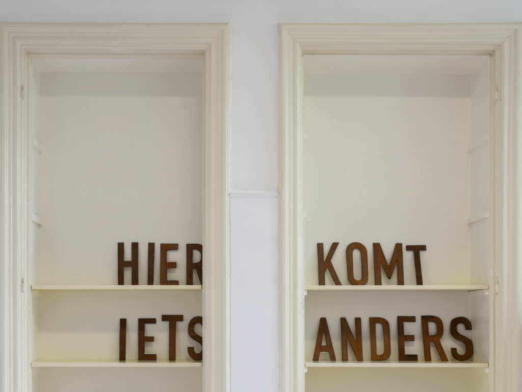 Two door frames fitted with shelves, displaying a few letters on them.