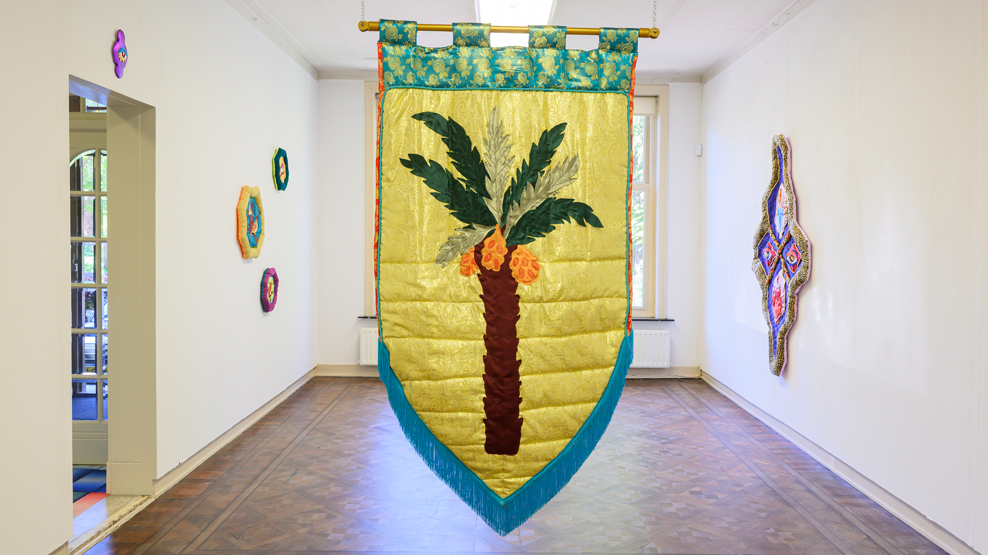 Colourful textile hanging in the middle of the room.