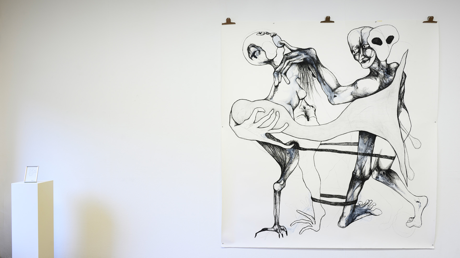 A big black and white illustration hanging from the wall.