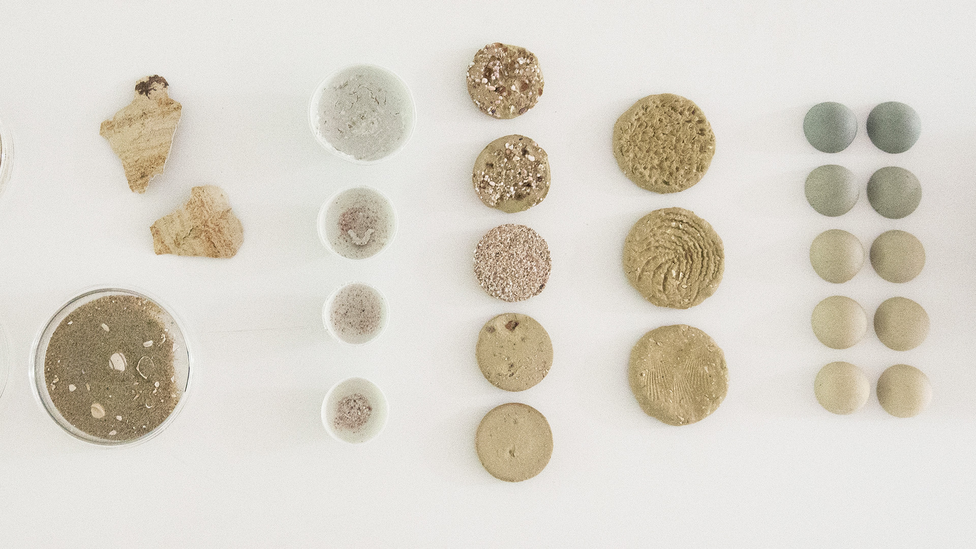 Samples of materials research on a white table.