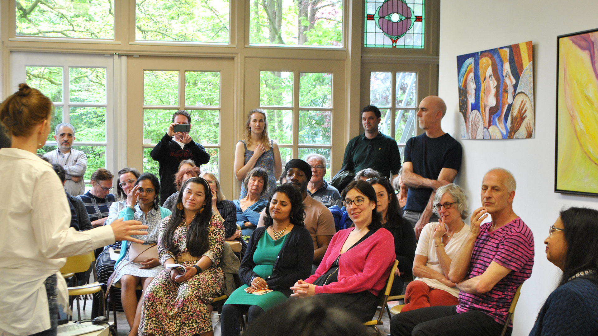 A big audience listening carefully to a lecture.