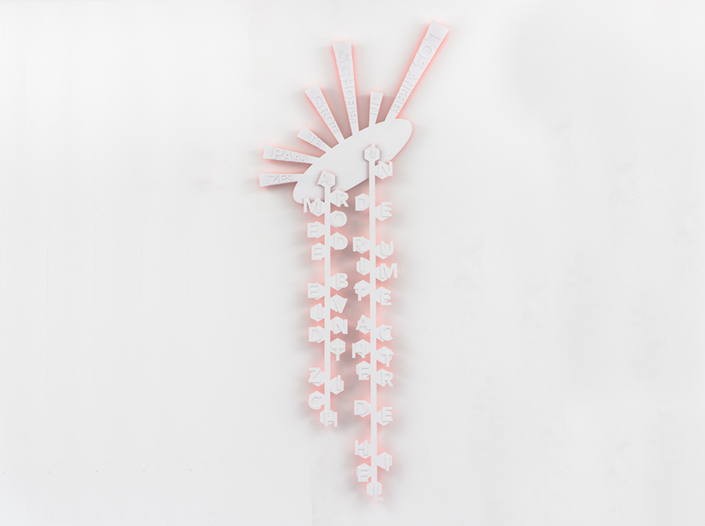Two vertical, white and pink typographic wall sculptures mounted on a white wall. Each piece has a central spine that is connected by a top main piece.