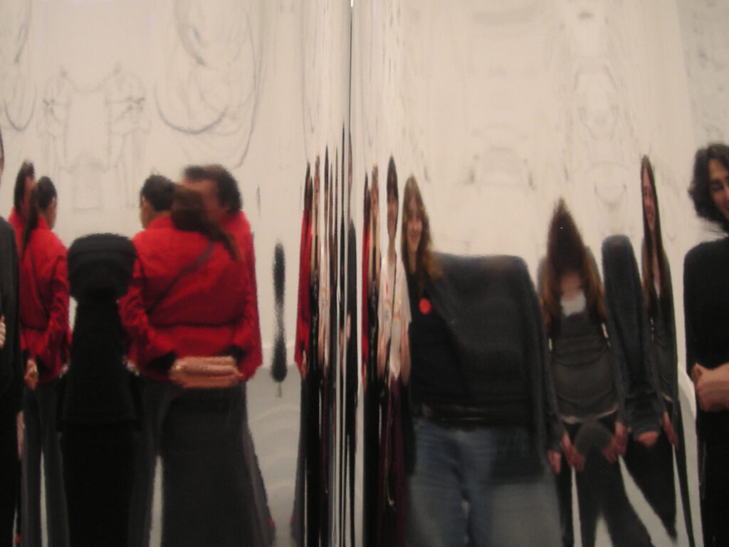 A group of young students in front of a mirror experiencing the exhibitions in the Van Abbemuseum.