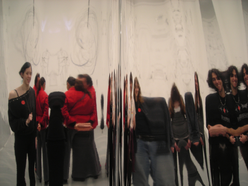 A group of young students in front of a mirror experiencing the exhibitions in the Van Abbemuseum.
