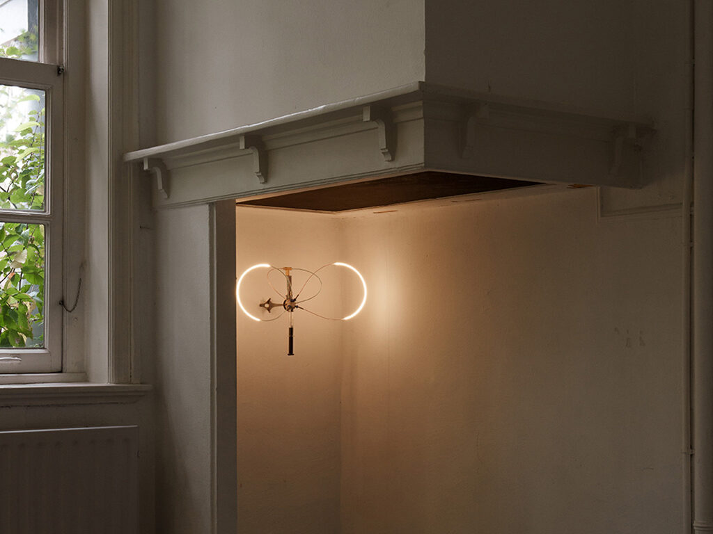 Designed light hanging on a white wall.
