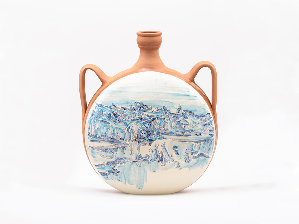 Image of a round terracotta ceramic vessel with two side handles and a narrow neck, featuring a blue-painted landscape of mountains and water on its front.