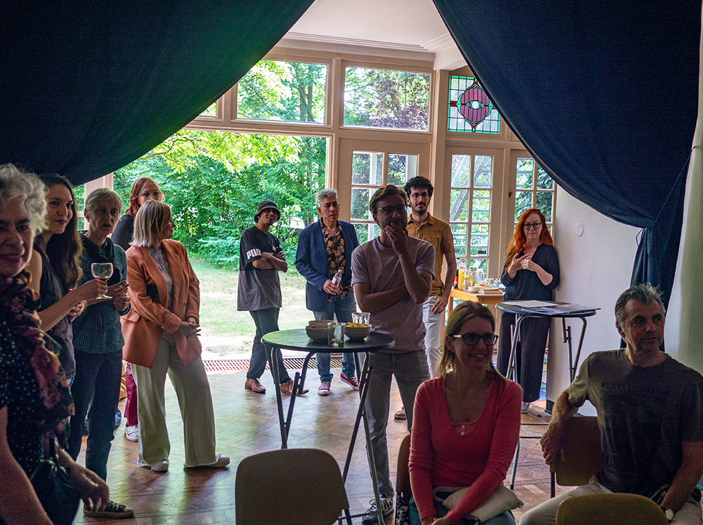 A big audience carefully listening to a live performance.