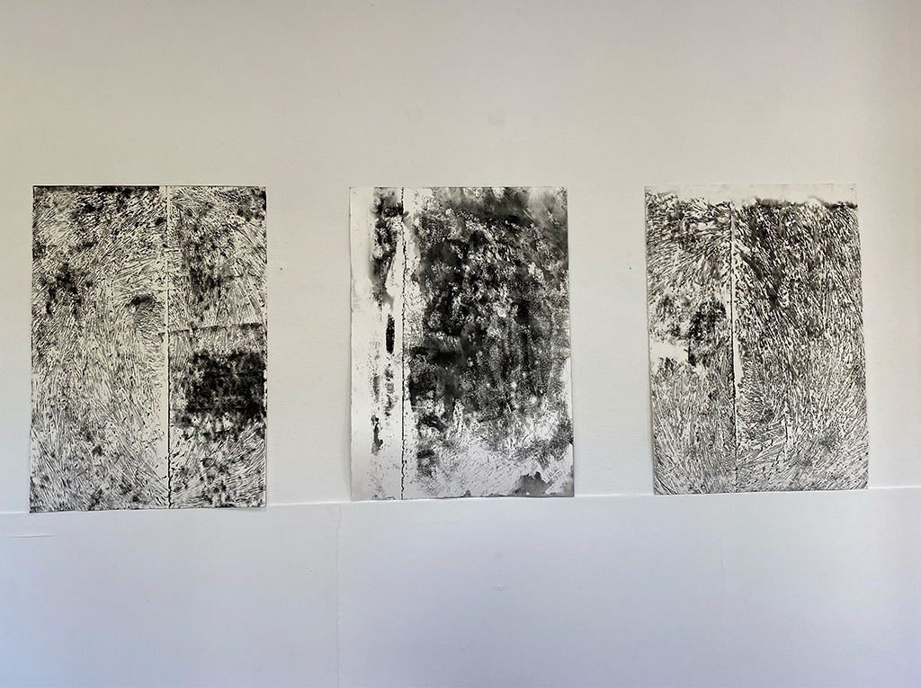 Some black and white sketches from maps hanging on the wall.