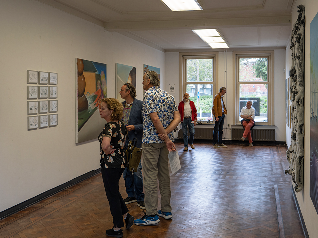 An exhibition space with visitors going around watching the art pieces.