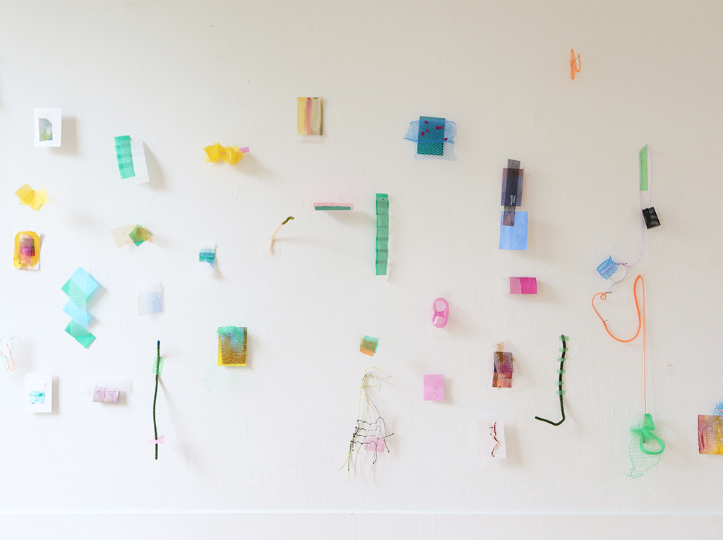 A series of small colourful objects hanging from the wall.