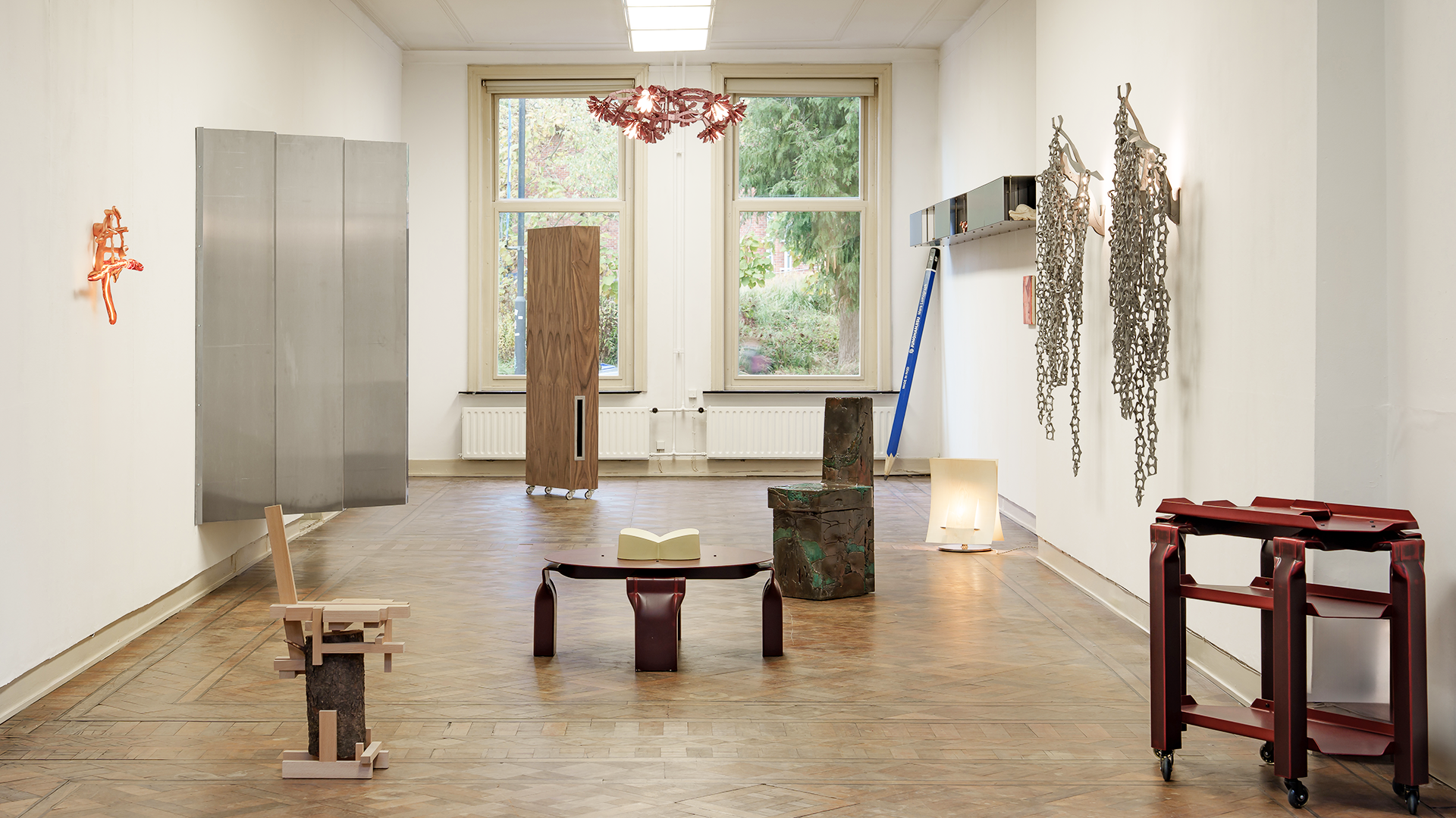 Overview of designed pieces in a large white room.