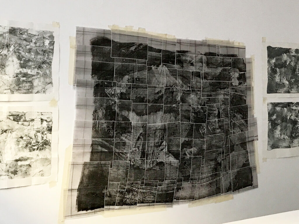 Textile maps hanging on the wall.