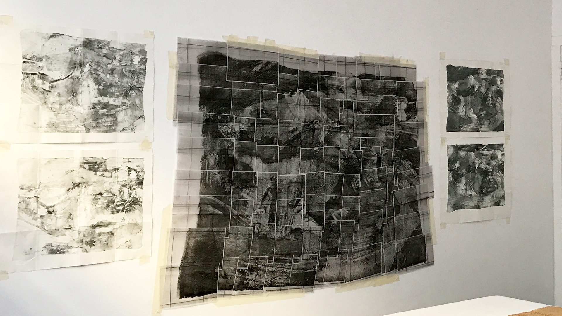 Textile maps hanging on the wall.