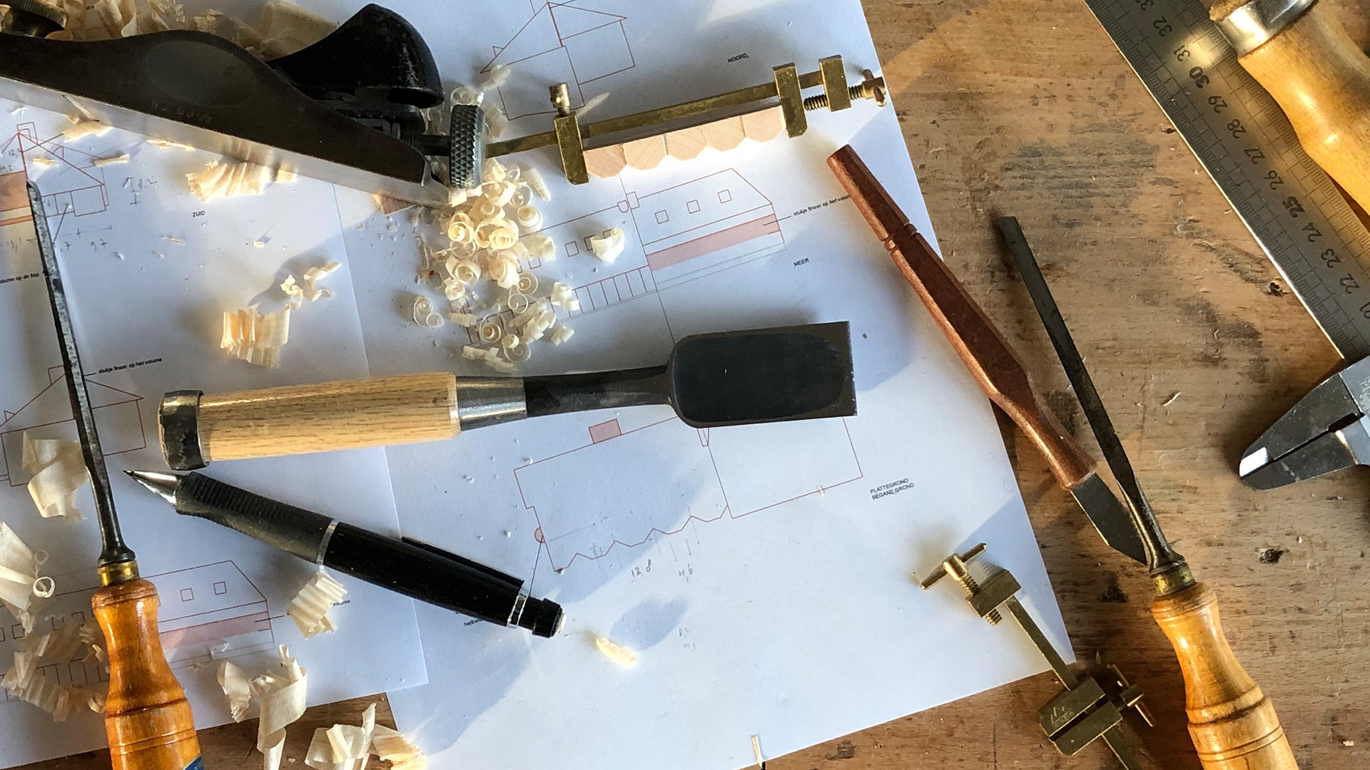 A table with pencils, paper and some tools to sketch.