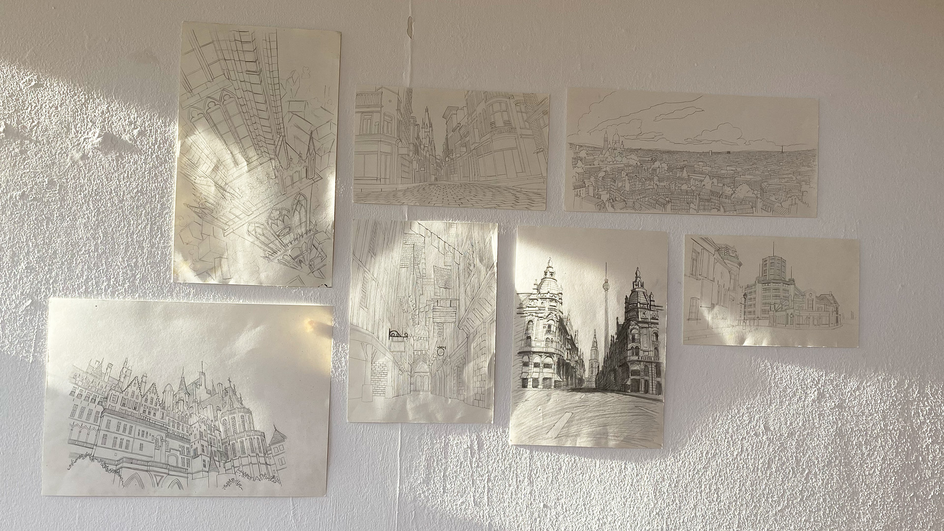 A white wall covered with delicate pencil sketches
