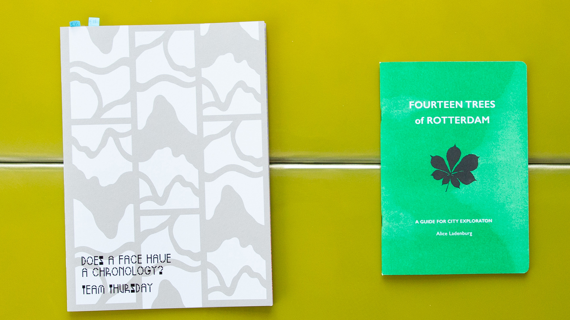 A bright yellowish green surface with two books.